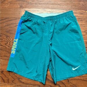 Men’s Nike Teal Shorts with Blue and Yellow Stripe accents for tennis